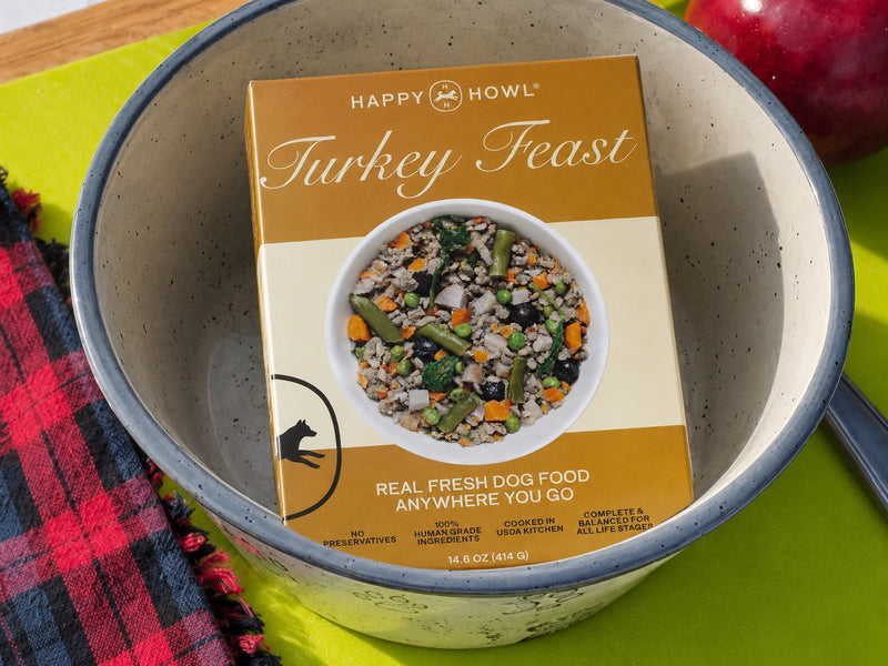 Package of Happy Howl Turkey Feast dog food in a bowl