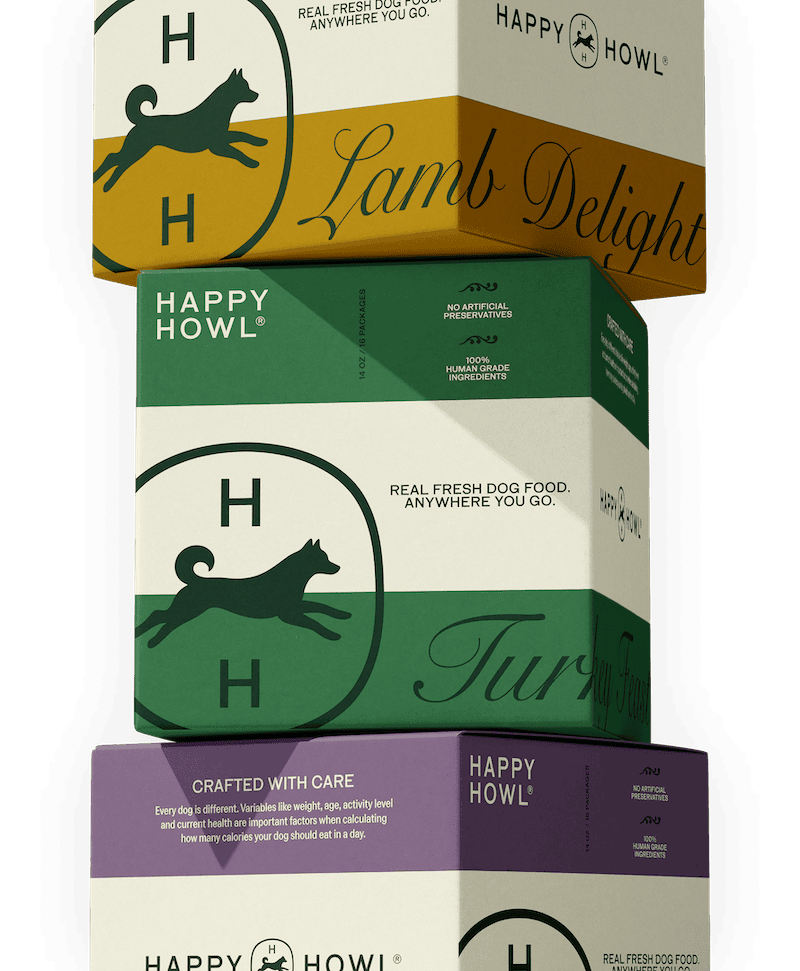 Stack of Happy Howl dog food boxes in various flavors